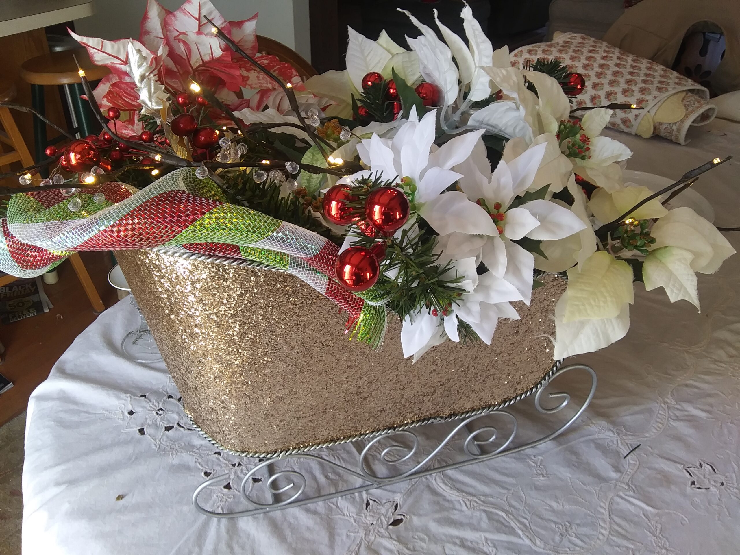 Side View of the Poinsettia Gold Glitter Sled Centerpiece