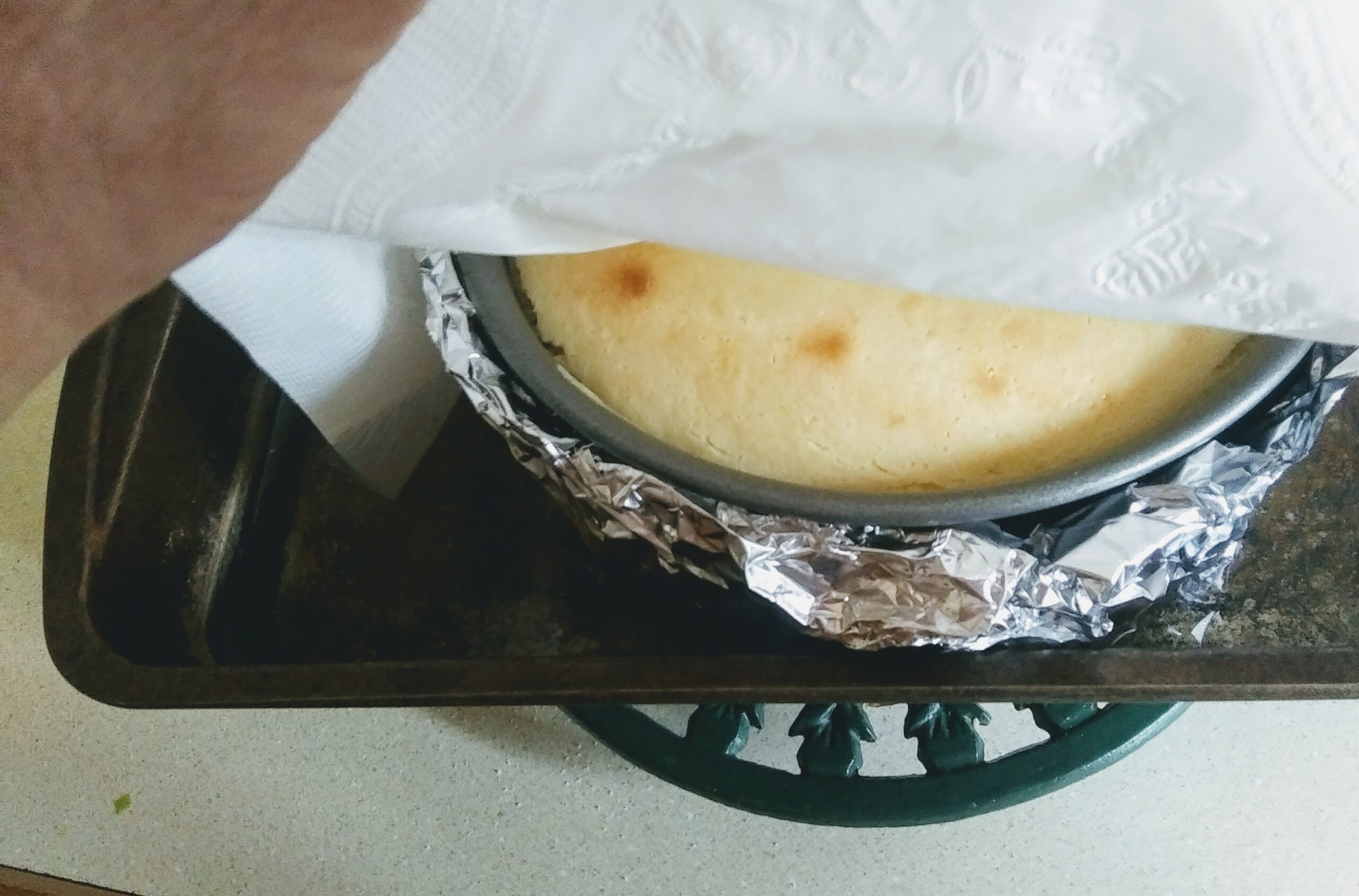 Paper Napkins Placed over Cooling Chesecake