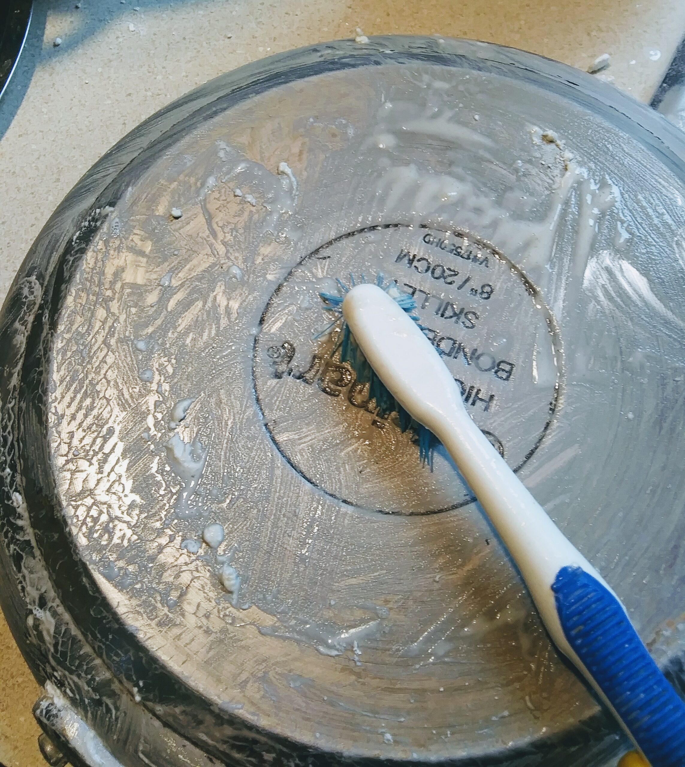 Scrubbing the Pan with an old Toothbrush