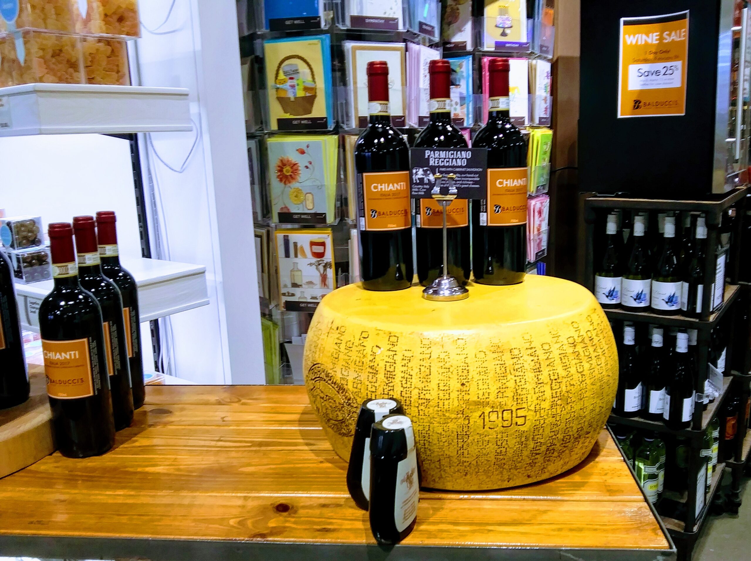 Huge Wheel of Aged Cheeese and Bottles of Chanti