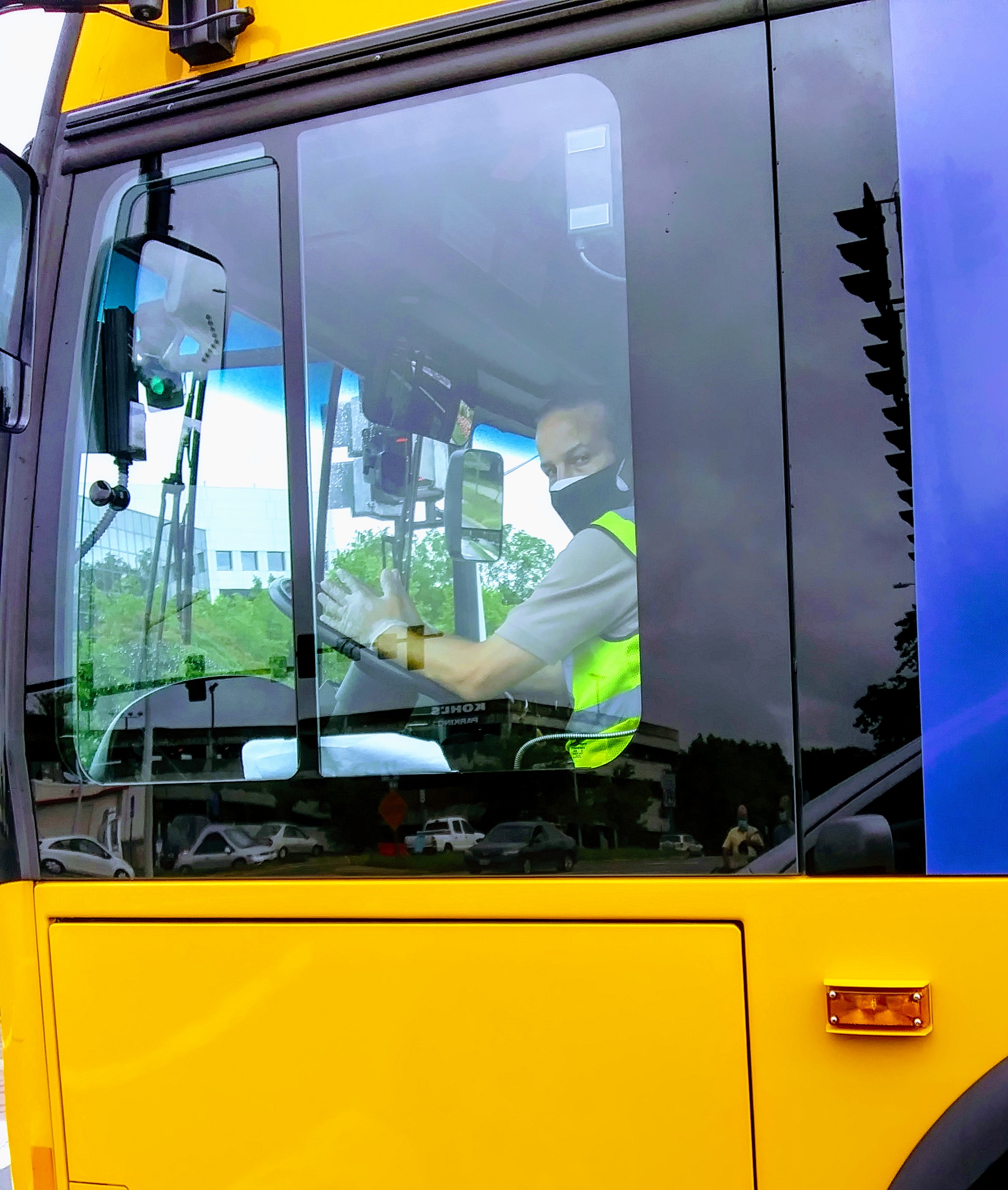 Waving Bus Driver Wearing Masks and Gloves