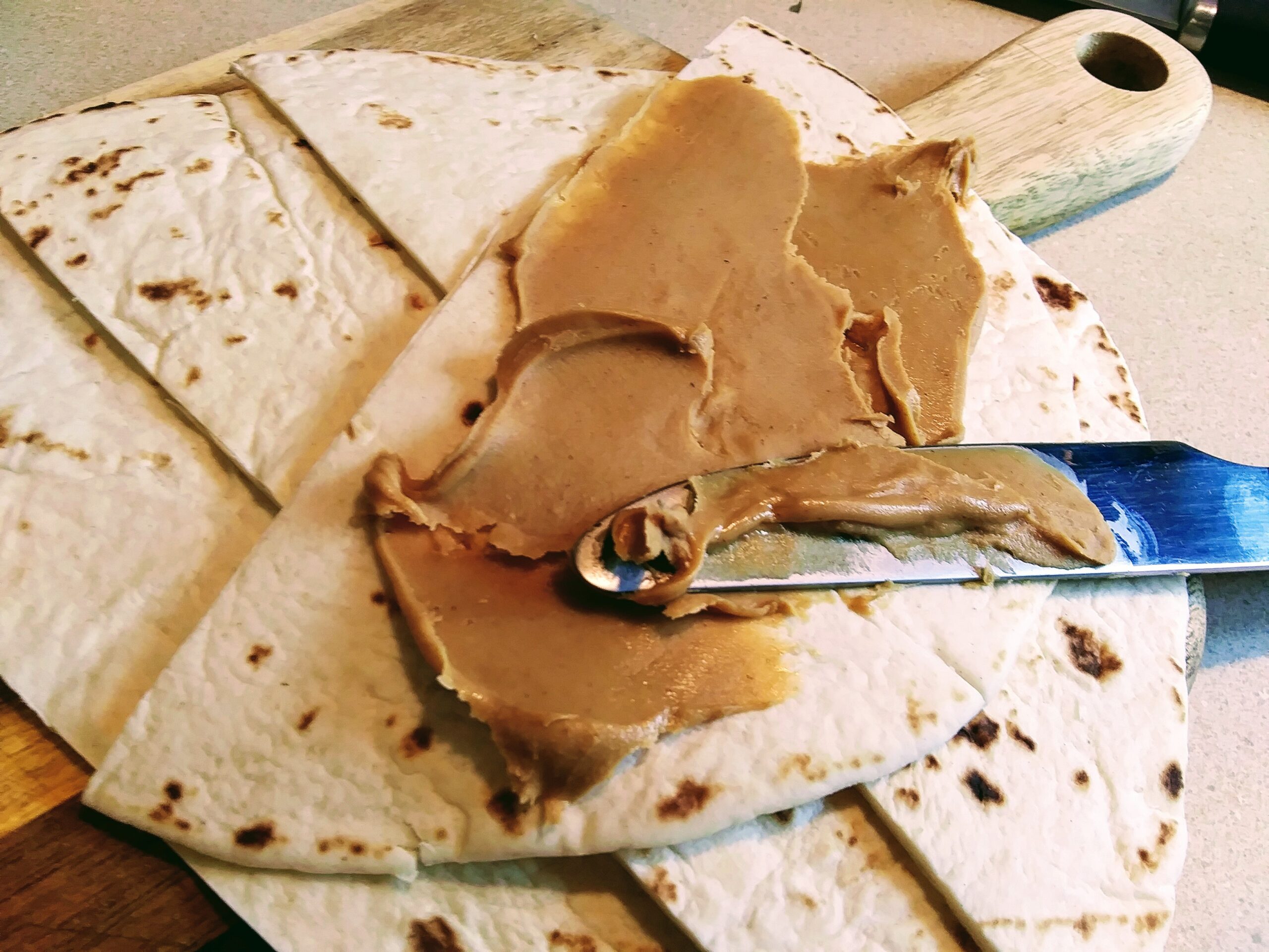 Spreading Peanut Butter on Pita Bread